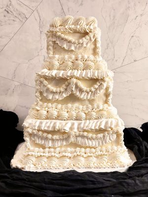 Four-tier vintage Lambeth-style wedding cake with elaborate piped buttercream, perfect for a retro-themed celebration in Central Florida.