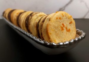 A tray of assorted French sablé butter cookies, featuring a variety of flavors and garnishes, perfect for elegant dessert tables at weddings and events in Orlando.