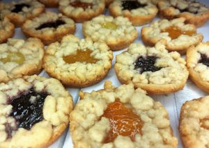 Assorted baby pies with a French shortbread base, buttery brown sugar streusel topping, and fruit fillings in blackberry, apricot, and lemon. A colorful and elegant dessert option for weddings, bridal showers, holidays, and party favors in Central Florida. Handmade by The Cookie Jar Orlando.