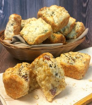 Golden brown bacon cheddar herb scones arranged in a rustic basket, ideal for breakfast catering at weddings, parties, and corporate events in Orlando, St. Augustine, Daytona, and the Central Florida region.