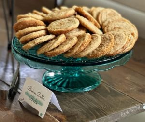 Brown butter brûlée cookies displayed on a teal glass stand at Paradise Cove Central Florida wedding.