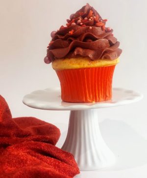A vanilla cupcake topped with rich buttercream swirled high and adorned with red sprinkles. This festive cupcake by The Cookie Jar Orlando is perfect for birthdays and Valentine’s day.