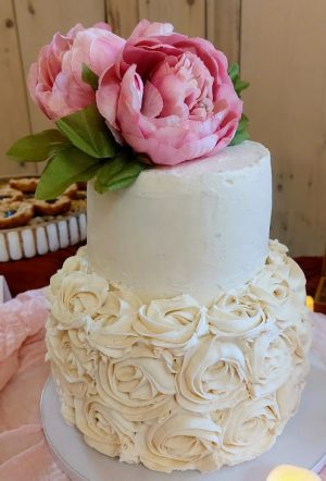 Two-tier rosette wedding cake with pink florals, perfect for rustic weddings at Barn at Hidden Oaks in Florida.