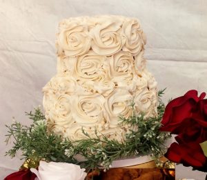 Two-tier wedding cake with ivory buttercream rosettes, ideal for romantic weddings in St. Augustine and Northeast Florida.