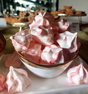 Red and white candy cane meringue cookies in a gold-trimmed bowl for Christmas parties and winter weddings in Central Florida, Orlando, St. Augustine, and Daytona.