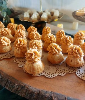 Caramel-topped mini bundt cakes on wood display for rustic weddings at Sterling Event Center, Orlando.