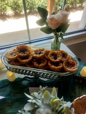 Cherry baby pies with crumble topping in a vintage-style dessert tray for weddings, showers, and parties across Central Florida, including Orlando, St. Augustine, and Daytona.
