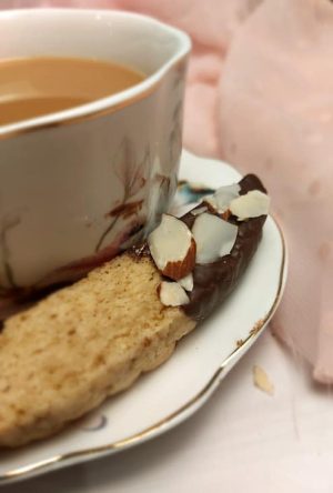 Chocolate almond biscotti beside teacup, ideal for bridal showers, weddings, or corporate events in Central Florida.