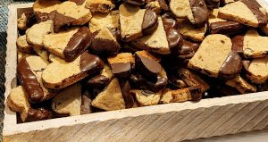 Chocolate chip blondies dipped in chocolate and served in a rustic wood tray for weddings, corporate events, and parties in Central Florida, Orlando, St. Augustine, and Daytona.