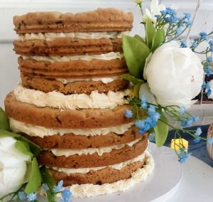 Layered chocolate chip cookie cake with buttercream and florals, perfect for weddings at Venue 1902 in Orlando.