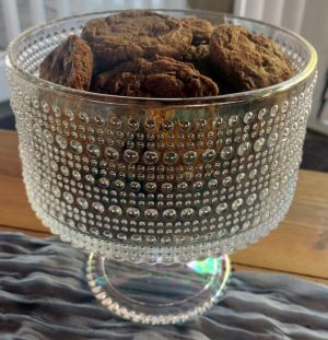Decadent chocolate cookies displayed in an elegant crystal beaded pedestal bowl at Paradise Cove, ideal for weddings, parties, and corporate events in Central Florida.