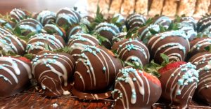 Chocolate covered strawberries with light blue and white drizzle, ideal for baby showers, weddings, and corporate events in Central Florida, including Orlando, Daytona, St. Augustine, and surrounding areas. A stylish treat for dessert tables and party favors.