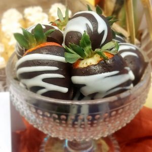 Dark chocolate covered strawberries with white chocolate drizzle served in a vintage glass bowl – a stylish and decadent treat for weddings, baby showers, and corporate events throughout Central Florida.