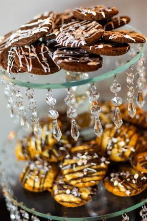 Chocolate and vanilla cookies drizzled in icing on a crystal chandelier stand, perfect for weddings, corporate events, and parties across Orlando, Daytona, and St. Augustine.