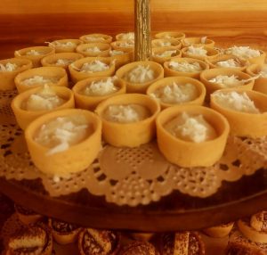 Mini coconut cream tartlets topped with shredded coconut on a wedding dessert display at Club Lake venue in Central Florida. A tropical-inspired treat perfect for beach weddings, summer receptions, and rustic dessert tables near Orlando.