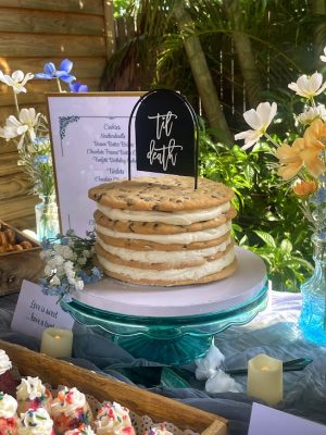 Stacked chocolate chip cookie cake with buttercream and “til death” topper at Rockledge Gardens wedding in Daytona area.
