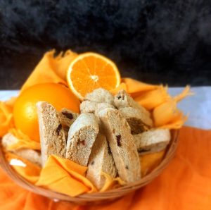 Cranberry orange biscotti in a bowl with fresh oranges for weddings and showers in Orlando and Central Florida.
