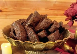 Dark chocolate biscotti cookies on gold tray for Orlando wedding dessert table at Club Lake Venue.
