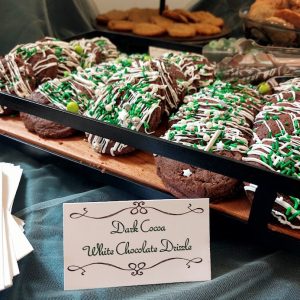 Dark cocoa cookies with white chocolate drizzle and green sprinkles at Venue 1902 in Central Florida.