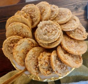 English toffee cookies displayed on gold-trimmed stand at a Parisian-themed wedding in Central Florida.