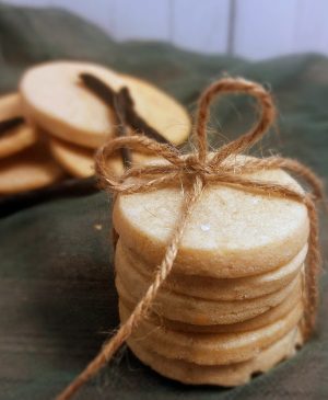 Stack of delicate vanilla bean French sablé cookies tied with rustic twine, ideal for weddings, bridal showers, and upscale dessert trays in St. Augustine and Central Florida.