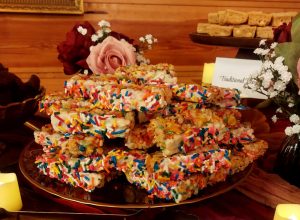 Fruity Rice Krispy treats dipped in white chocolate and rainbow sprinkles for weddings, parties, and showers in Central Florida, Orlando, Daytona, and St. Augustine.