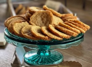 Golden butter cookies arranged on teal glass stand for weddings and parties at Paradise Cove Orlando.