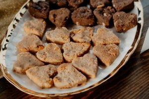 Heart-shaped blondies and brownies arranged on a white and gold tray, part of a Parisian elegance-inspired wedding dessert table at Casani Estates in Central Florida. A charming and romantic dessert detail by The Cookie Jar Orlando for weddings and bridal showers.