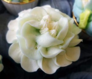 Elegant ivory buttercream cupcake piped to resemble a delicate flower, ideal for weddings, bridal showers, baby showers, and Mother's Day events.