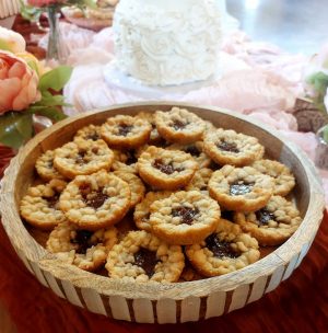 Mini baby pies on rustic tray at Barn at Hidden Oaks wedding dessert table in Central Florida.