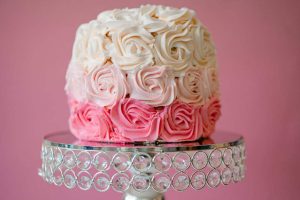 Pink ombre rosette cake on a crystal stand for quinceañeras, birthdays, and sweet sixteens in Central Florida.