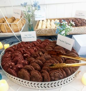 Red velvet and chocolate espresso cookies displayed on elegant trays for a wedding dessert table at Venue 1902 Orlando.