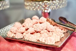 Elegant tray of pink French meringues on a sparkling dessert table at a Sweet Sixteen and Quinceañera celebration at D'Space Venue in Orlando.