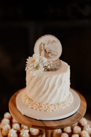Rustic buttercream cutting cake with floral accents and custom topper for Orlando weddings and elopements.