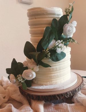 Textured buttercream wedding cake with white florals and greenery at Sterling Event Center in Orlando.