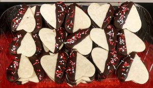 Heart-shaped shortbread cookies dipped in chocolate and topped with red, pink, and white sprinkles, perfect for Valentine’s Day dessert tables at weddings, parties, and corporate events in Central Florida, including Orlando, St. Augustine, and Daytona.