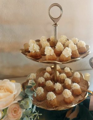 Vanilla mini bundt cakes with buttercream frosting on gold stand for Orlando garden weddings at Sterling.