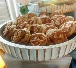 Rustic peanut butter cookies topped with pretzels, displayed for a wedding dessert table at Paradise Cove in Orlando.