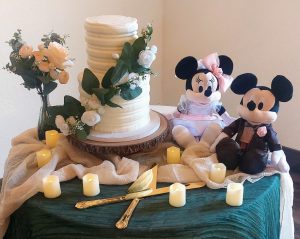 Whimsical buttercream wedding cake with flowers and Mickey Minnie accents at Sterling Event Center, Orlando.